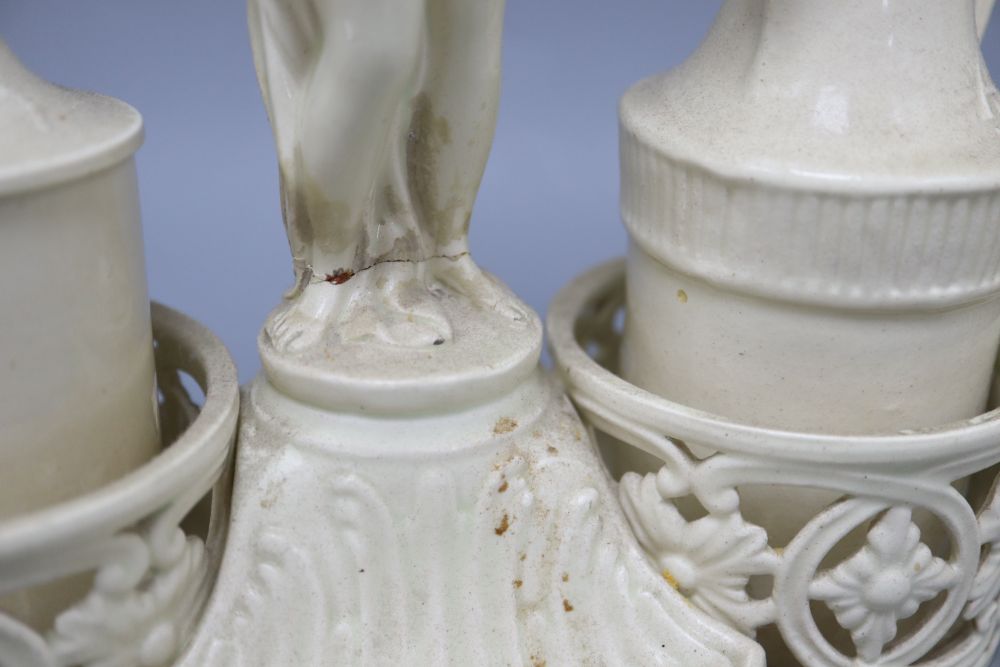 Two 19th century pearlware cruets and a pair of candlesticks, tallest 25cm